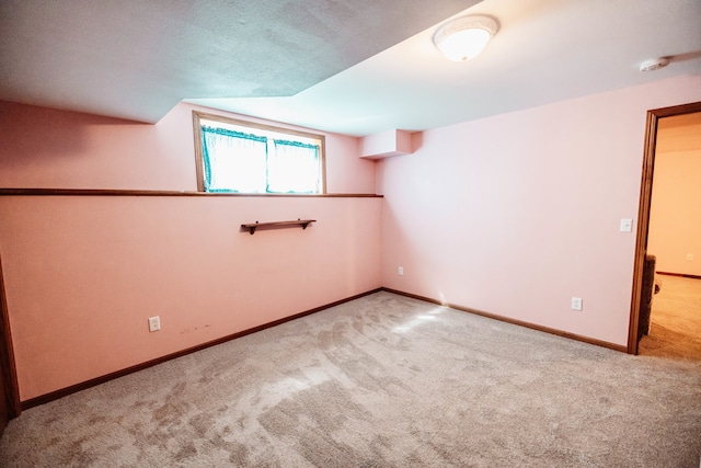 carpeted spare room featuring a textured ceiling