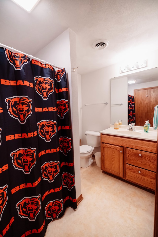 bathroom with vanity, toilet, and walk in shower