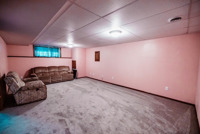 basement with a paneled ceiling and carpet