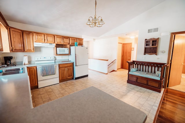 kitchen with hanging light fixtures, white appliances, a chandelier, sink, and high vaulted ceiling