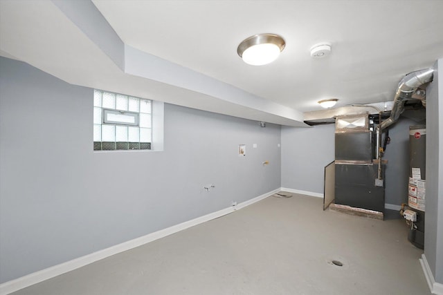 below grade area featuring heating unit and gas water heater