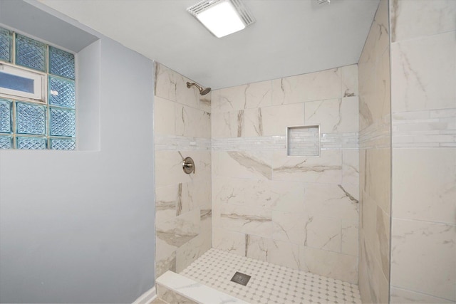 bathroom with tiled shower