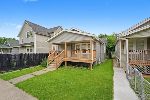 view of front of home with covered porch, a fenced backyard, and stairway