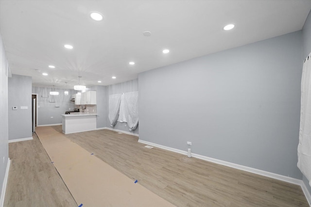 unfurnished living room with light wood-style floors and recessed lighting