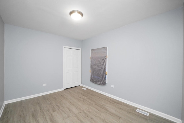unfurnished room featuring wood finished floors and baseboards