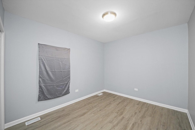 unfurnished room with wood finished floors and baseboards