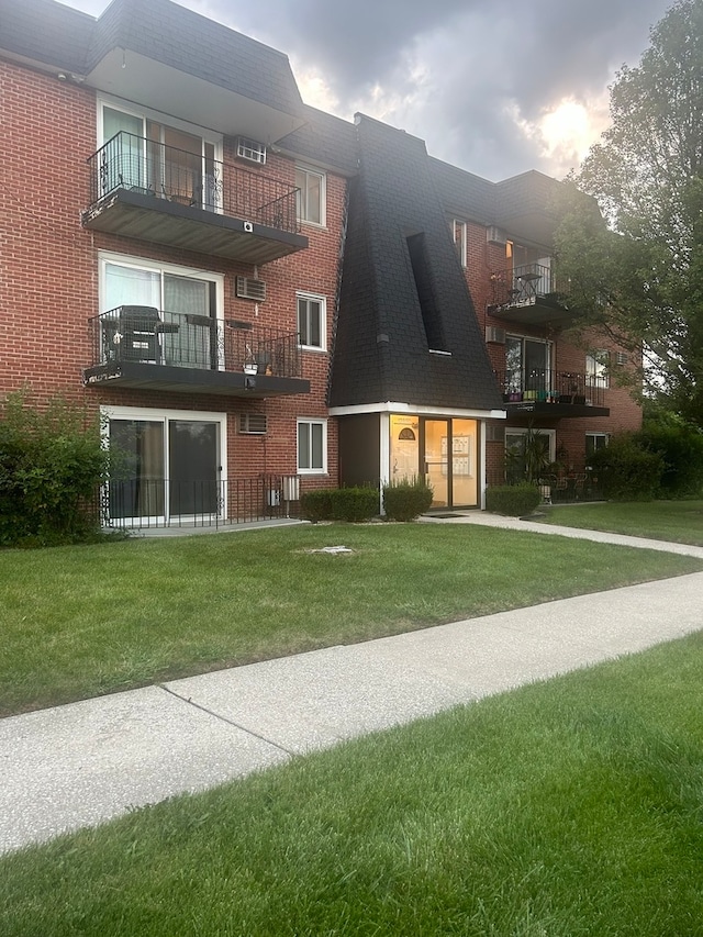 exterior space featuring a balcony and a yard