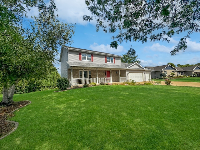 view of front facade featuring a front lawn, covered porch, and a garage