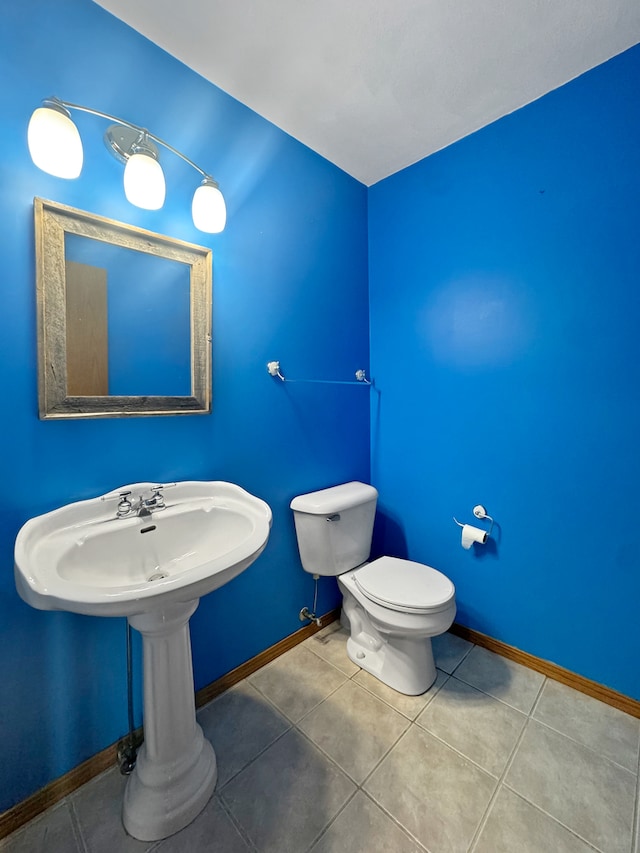 bathroom with tile patterned flooring and toilet