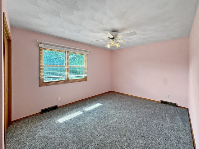 carpeted empty room with a textured ceiling and ceiling fan