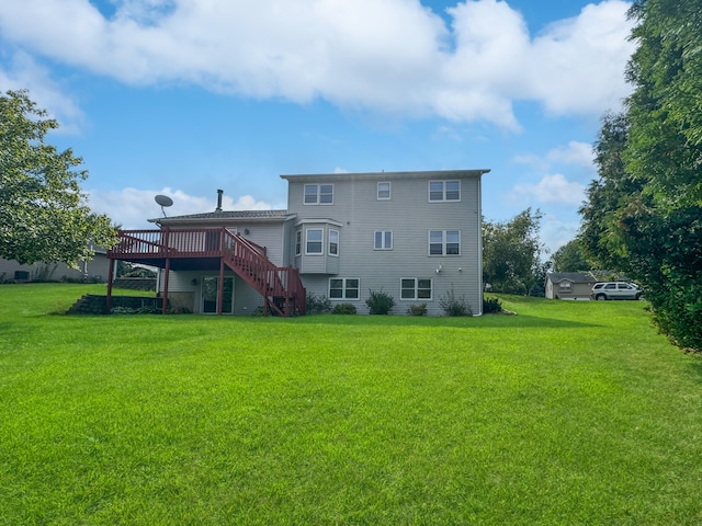 back of house with a wooden deck and a lawn