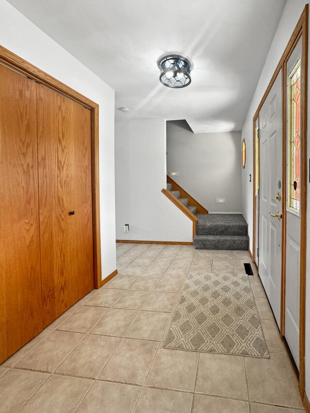 foyer featuring light tile patterned floors