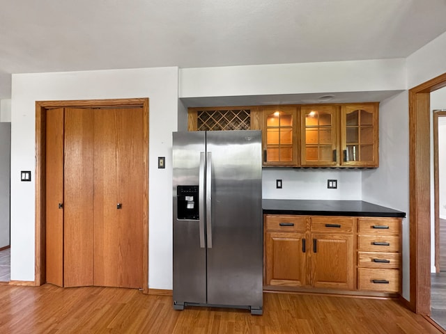 kitchen with stainless steel fridge and light wood-type flooring