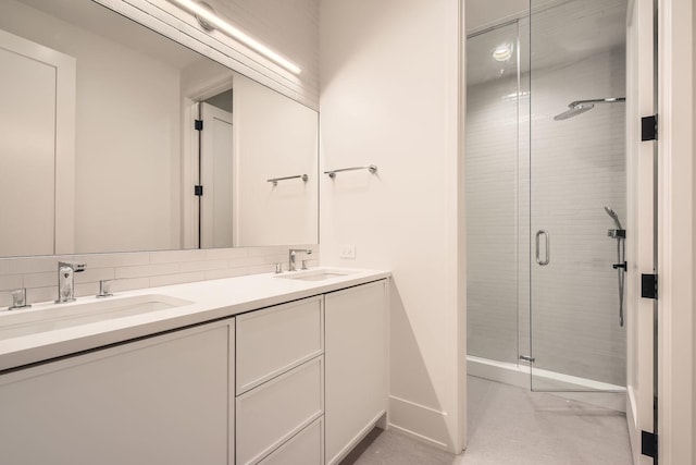 bathroom featuring vanity, an enclosed shower, and backsplash