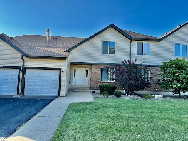 view of front facade with a garage and a front lawn