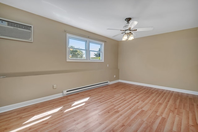 spare room with a baseboard heating unit, light hardwood / wood-style flooring, ceiling fan, and a wall unit AC