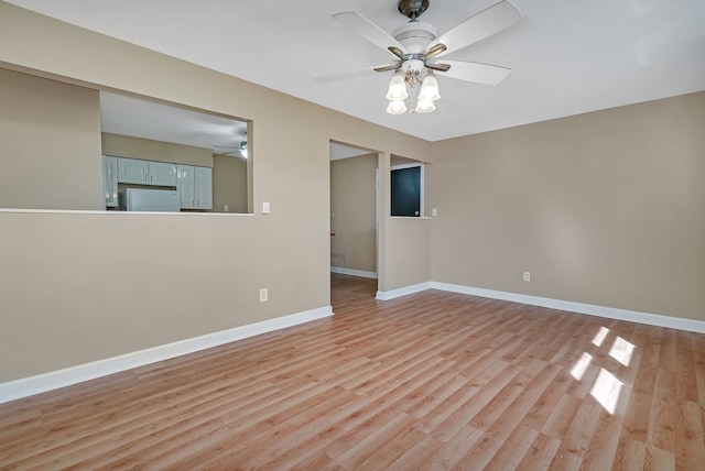 unfurnished room featuring ceiling fan and light hardwood / wood-style floors