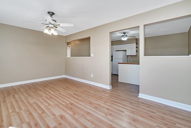 unfurnished room with ceiling fan and light hardwood / wood-style floors