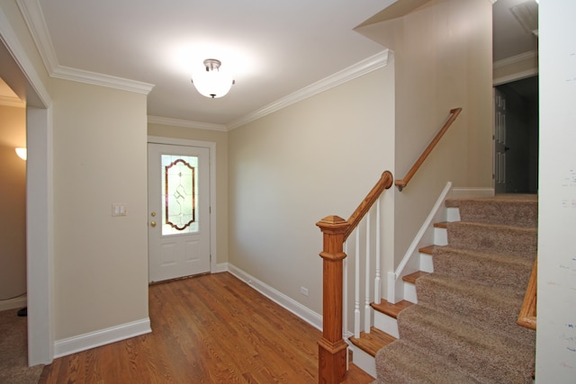 foyer featuring ornamental molding and hardwood / wood-style floors