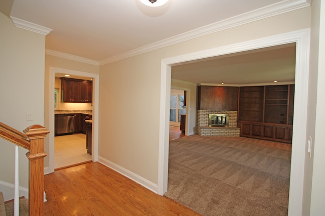 hall with light hardwood / wood-style flooring and ornamental molding