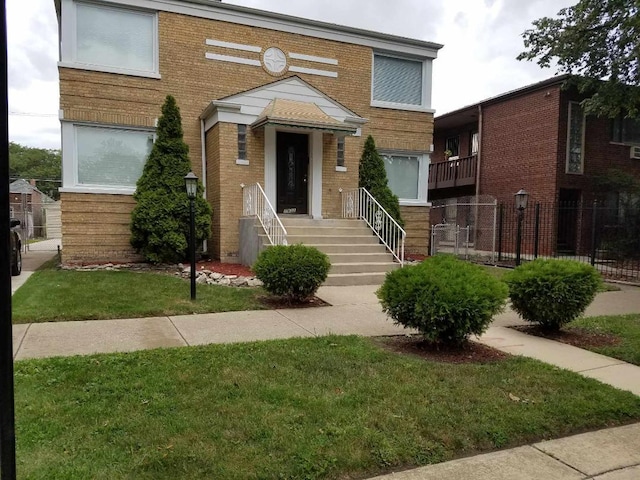 view of front of property featuring a front lawn and a balcony