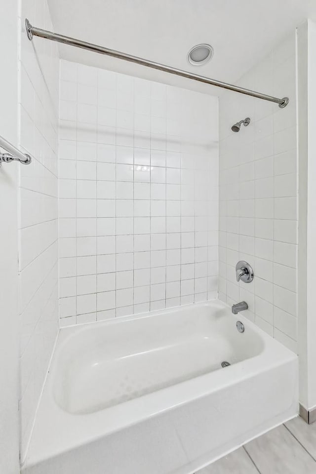 bathroom featuring tiled shower / bath and tile patterned floors