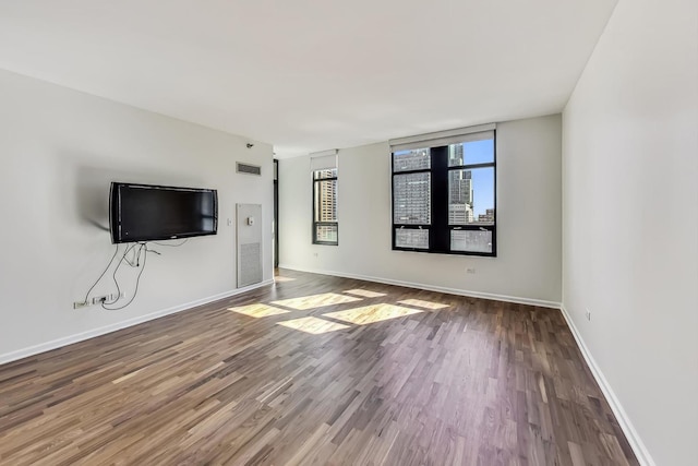 unfurnished living room with hardwood / wood-style flooring