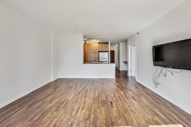 unfurnished living room with wood-type flooring