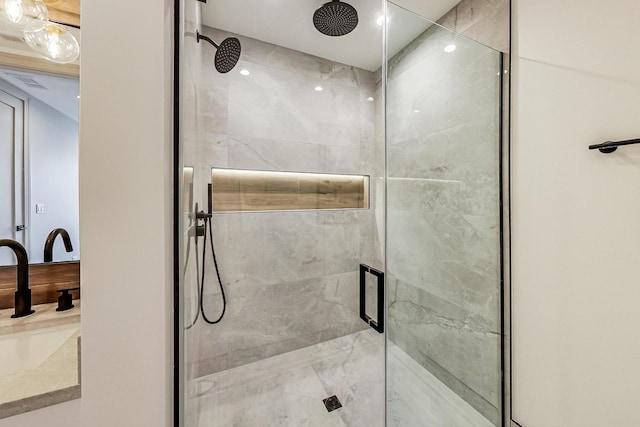 bathroom featuring vanity and a shower with door