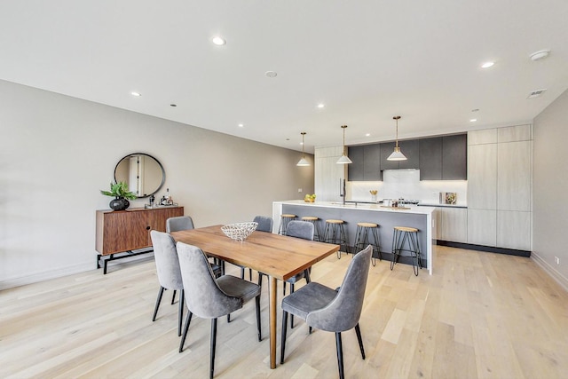 dining space with light hardwood / wood-style floors