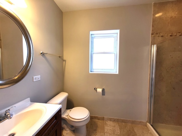 bathroom featuring vanity, toilet, and walk in shower