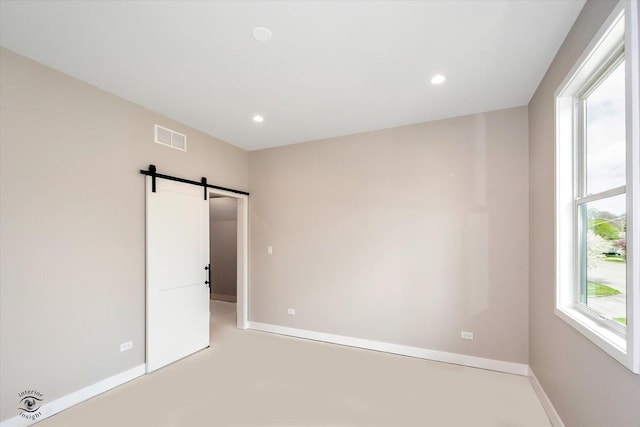 135 W 18th St, Lockport, IL 60441 - empty room featuring a barn door, baseboards, and recessed lighting