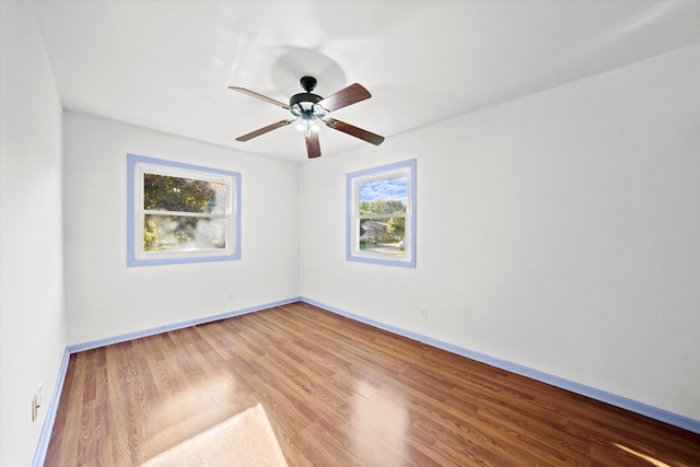 unfurnished room with ceiling fan and hardwood / wood-style floors