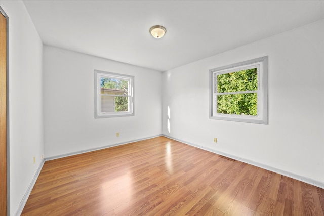 spare room with hardwood / wood-style floors