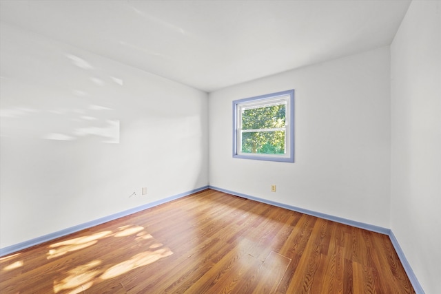 unfurnished room with hardwood / wood-style floors