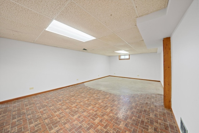 basement featuring a paneled ceiling