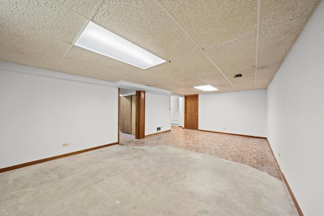 basement with a paneled ceiling