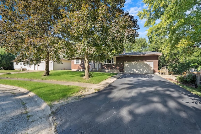 view of front of property featuring a garage and a front yard