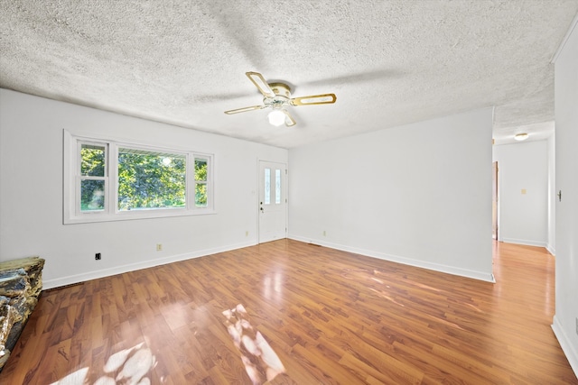 spare room featuring a textured ceiling, hardwood / wood-style flooring, and ceiling fan