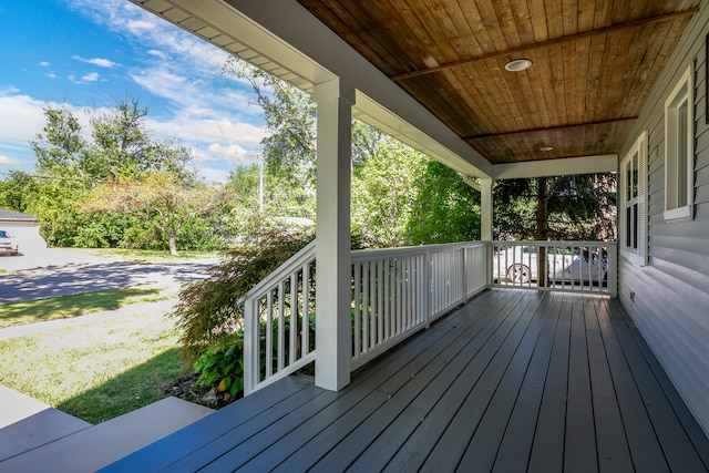 wooden terrace with a yard and a porch