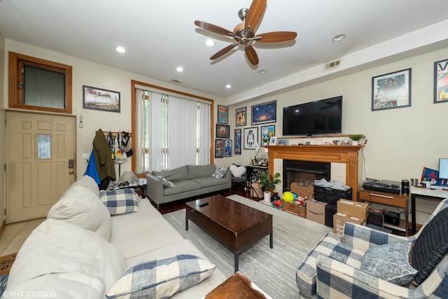 living room with ceiling fan and light tile patterned floors