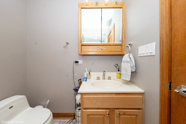 bathroom with tile patterned flooring, vanity, and toilet