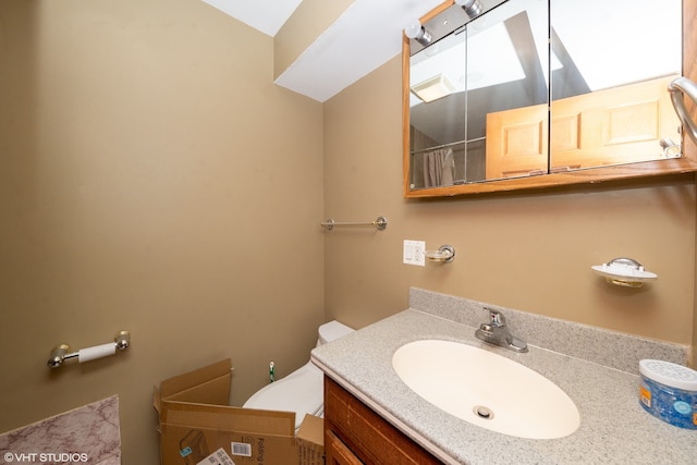 bathroom featuring vanity and toilet