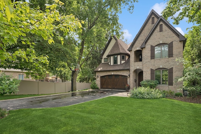 view of front of house with a front lawn and a garage