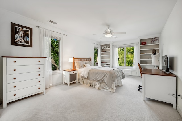 bedroom with ceiling fan and light carpet