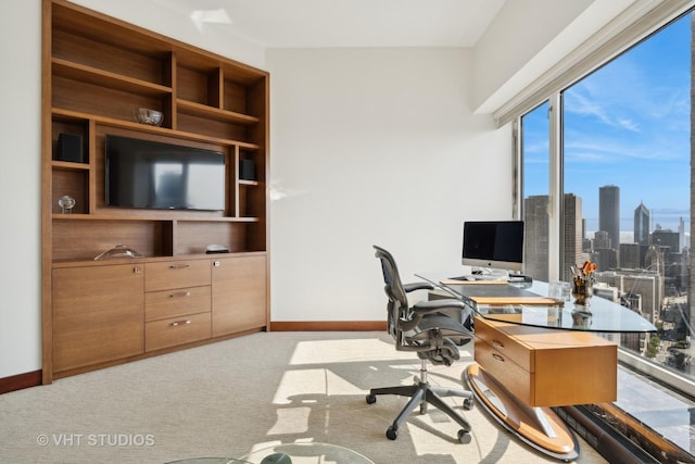 carpeted office space featuring baseboards