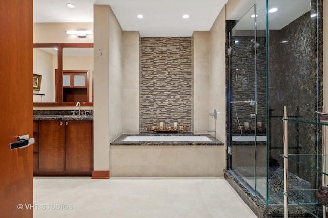 full bath featuring a stall shower, vanity, and a bath