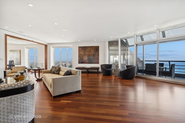 living room with recessed lighting, floor to ceiling windows, and wood finished floors