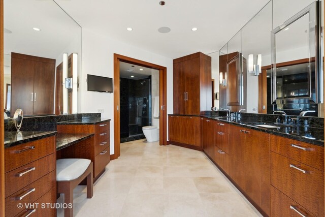 bathroom with tiled shower, tile walls, and toilet