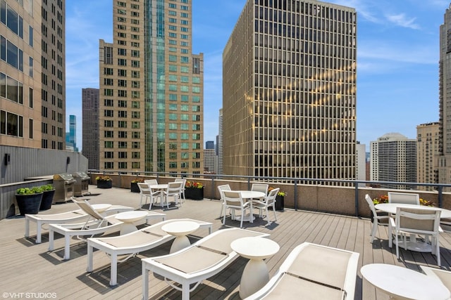 view of patio featuring a view of city and outdoor dining area